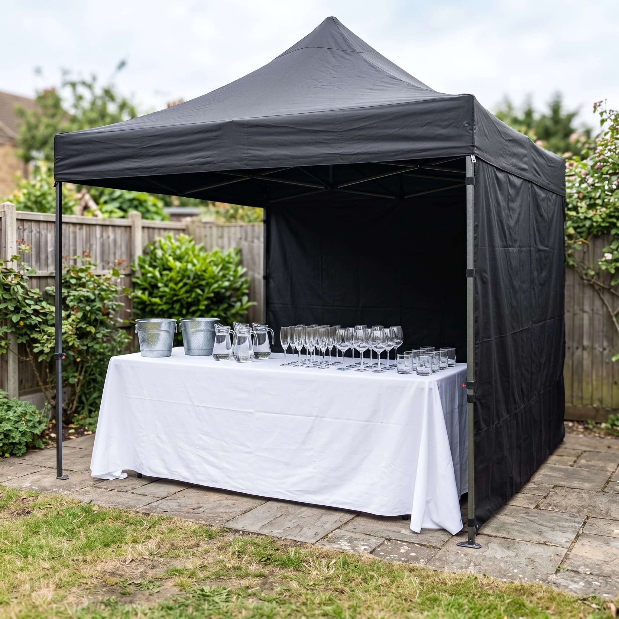 Full bar setup package hire London — gazebo, table, glassware and ice buckets set up for your event